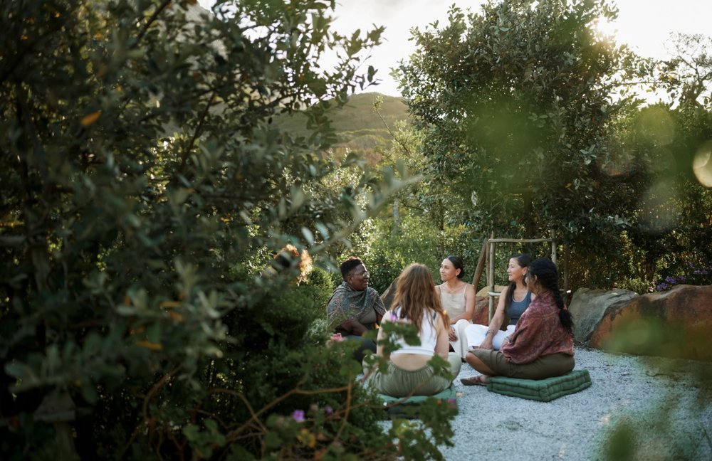 Women gathered in circle in nature
